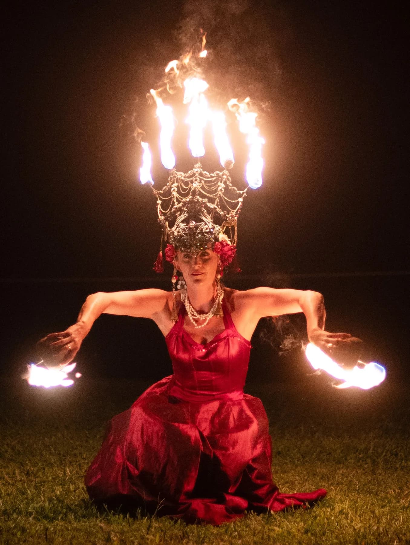 Performer in a fire crown costume at night