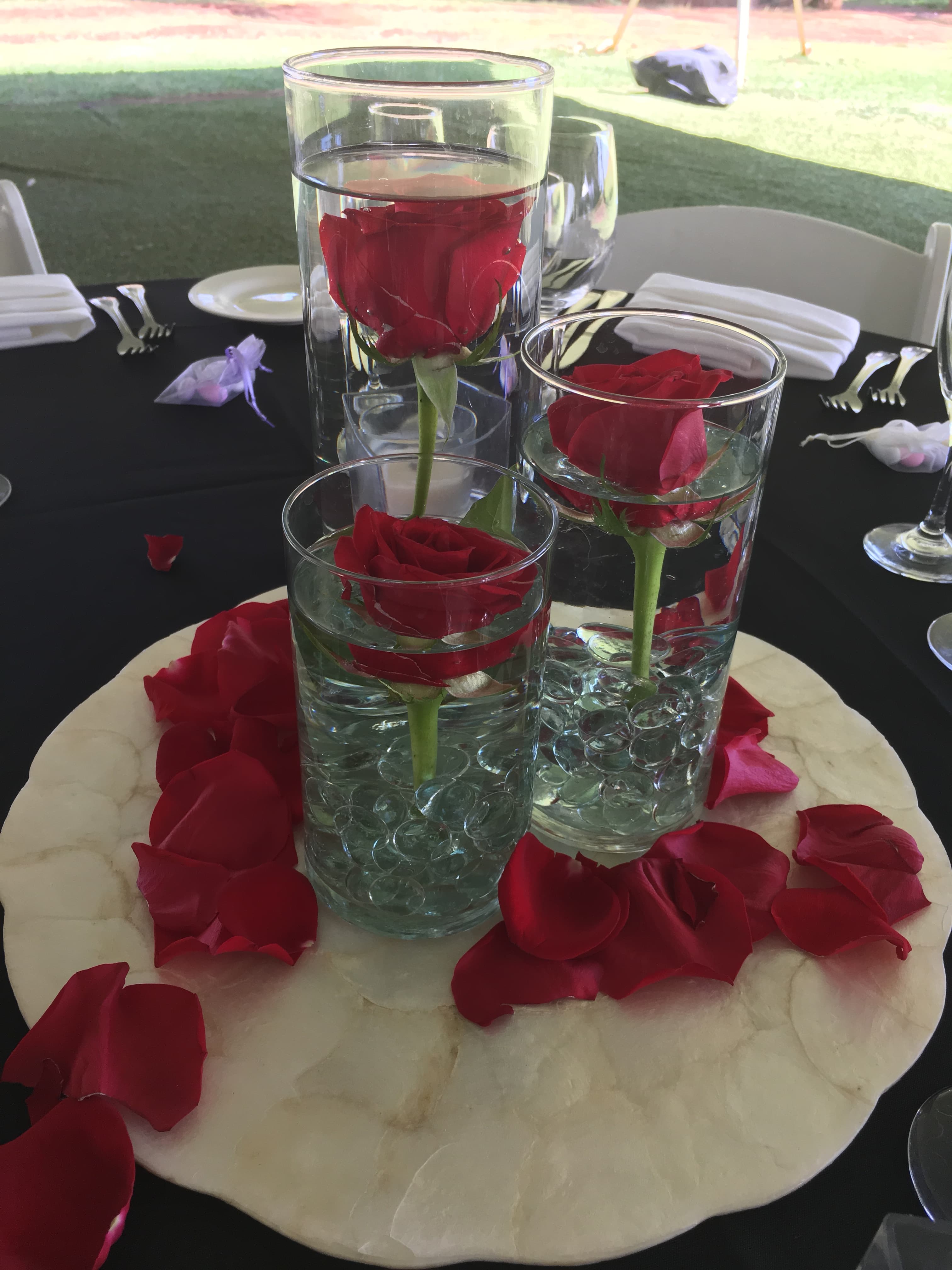 Floating red rose decor arranged above an event table